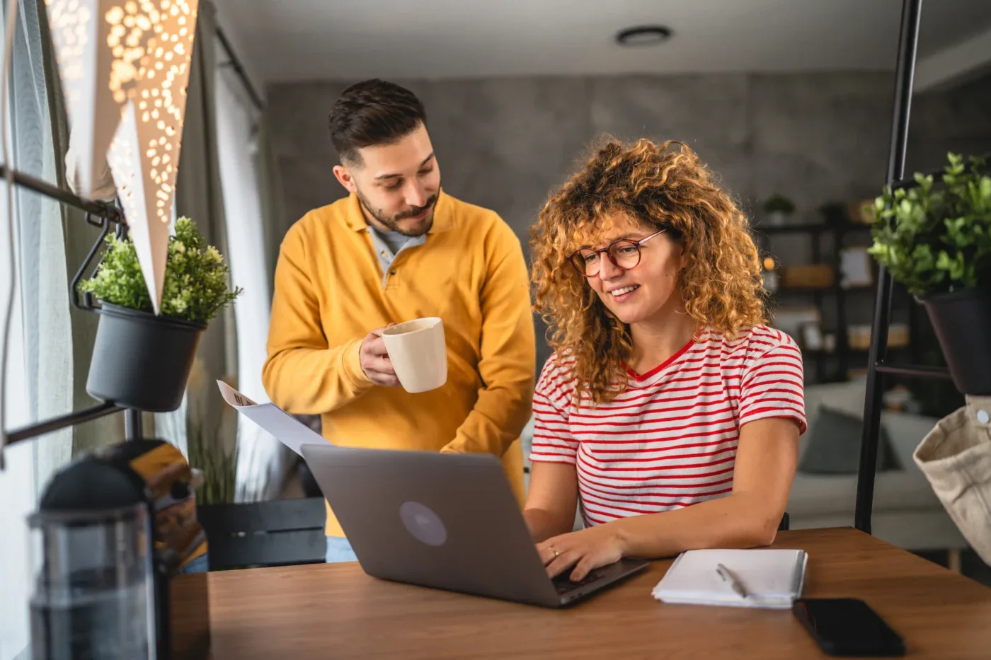 A happy couple leaves a review on their computer for a window blinds and shades replacement in Arizona and Las Vegas Valley region | Southwest Blinds and Shutters