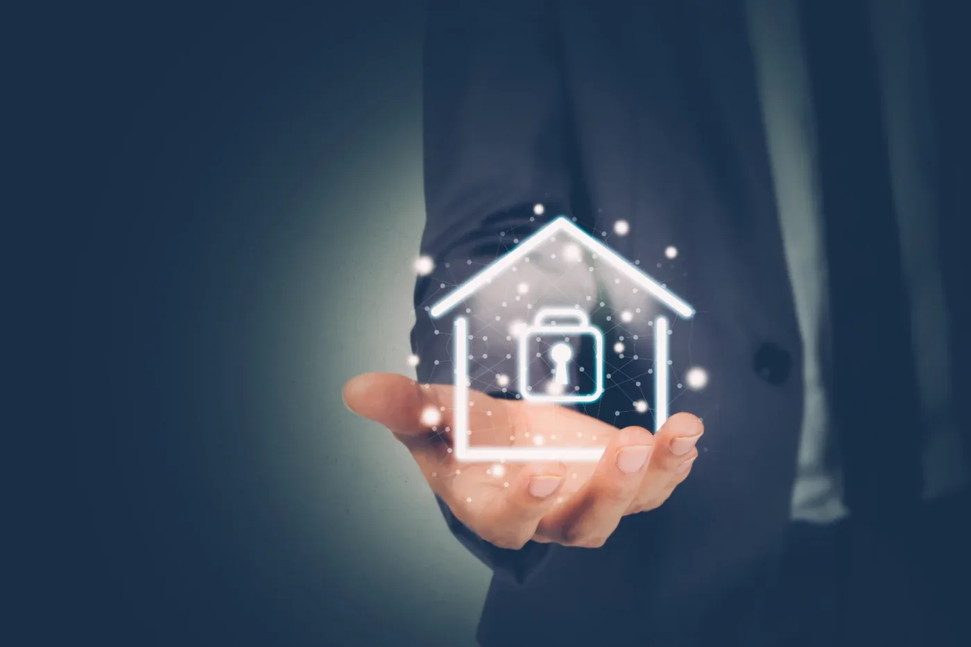 A person holding a home security symbol