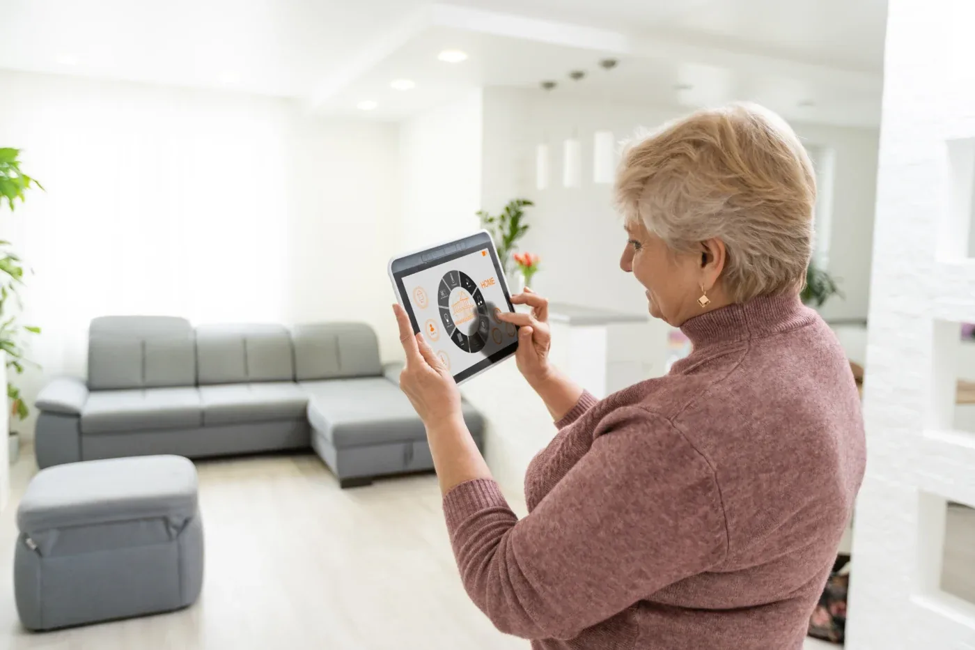 A person adjusts her shading solutions with home automation