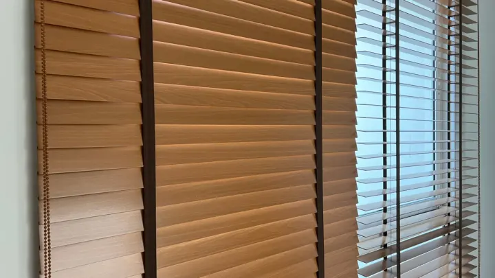 Wood blinds on windows with one open and one closed