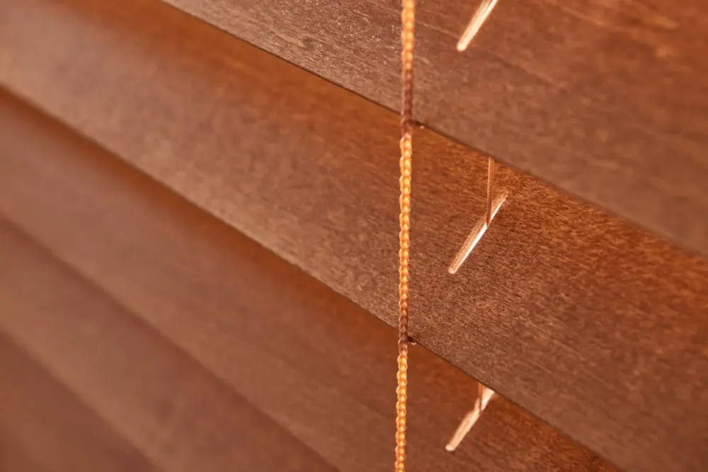 A close-up of brown wood blinds.