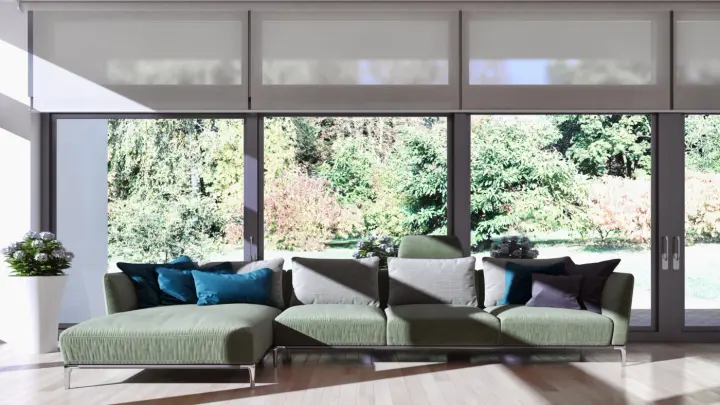A living room with a wall of windows with motorized shades half open