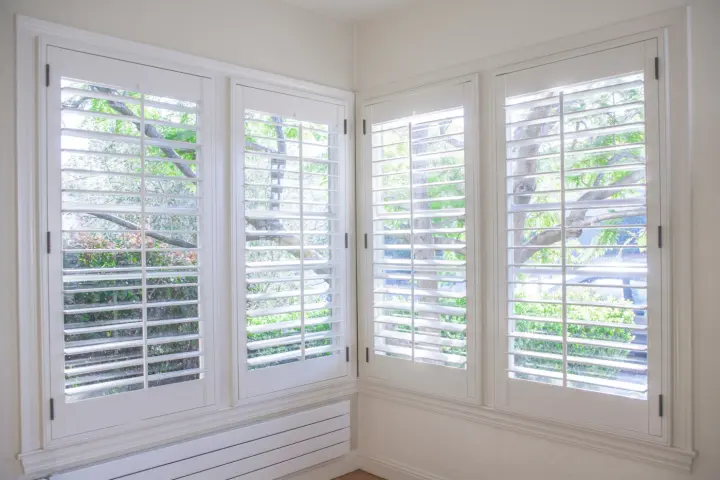 White composite shutters over windows in Las Vegas home | Southwest Blinds and Shutters