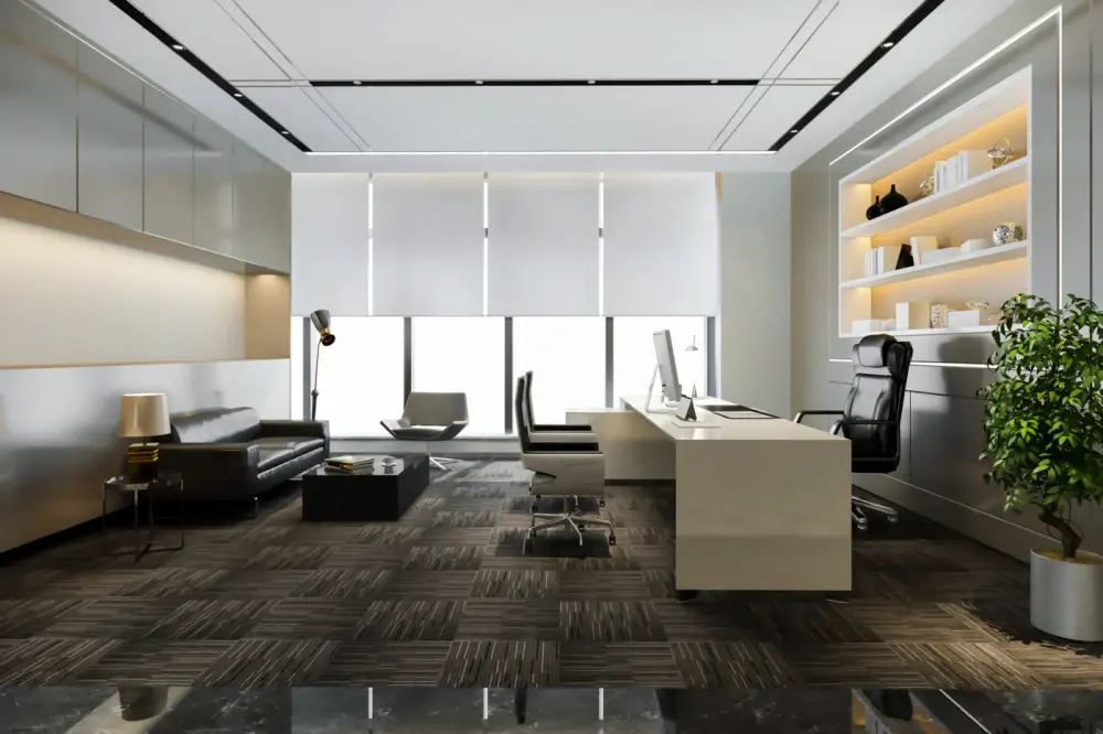 This image features an office area with chairs and a long table. The windows have motorized shades.