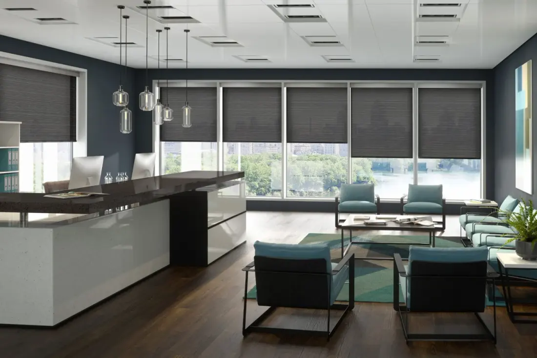 A kitchen and sitting area in a Maricopa County home with gray roller shades over the windows.