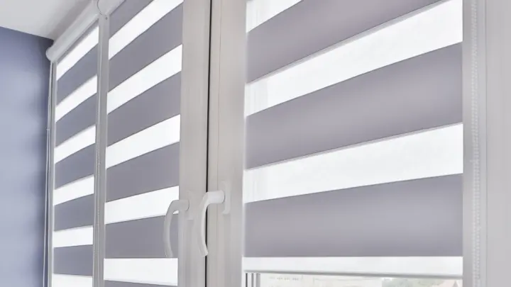 Close-up of large white window shutters