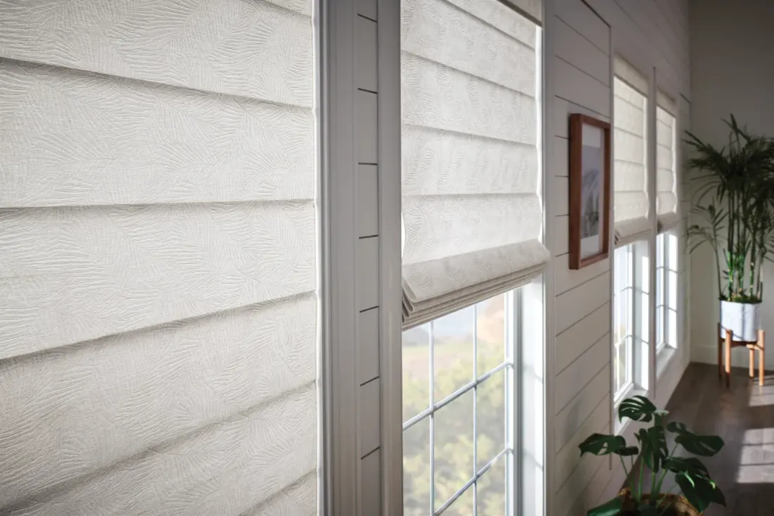 Close-up of classic white motorized shades.