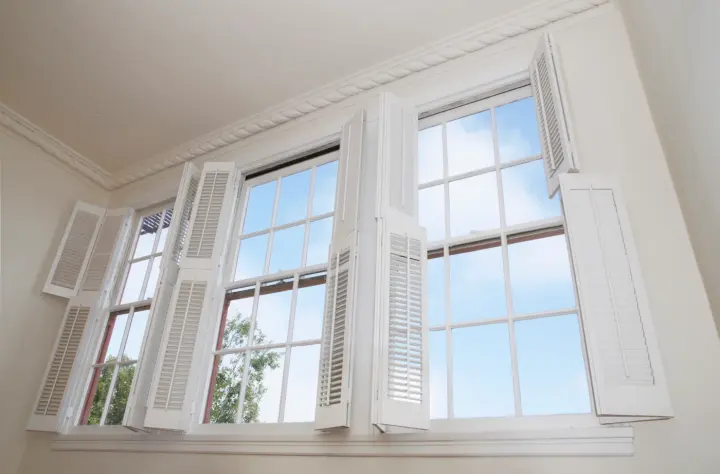 White shutters open on windows