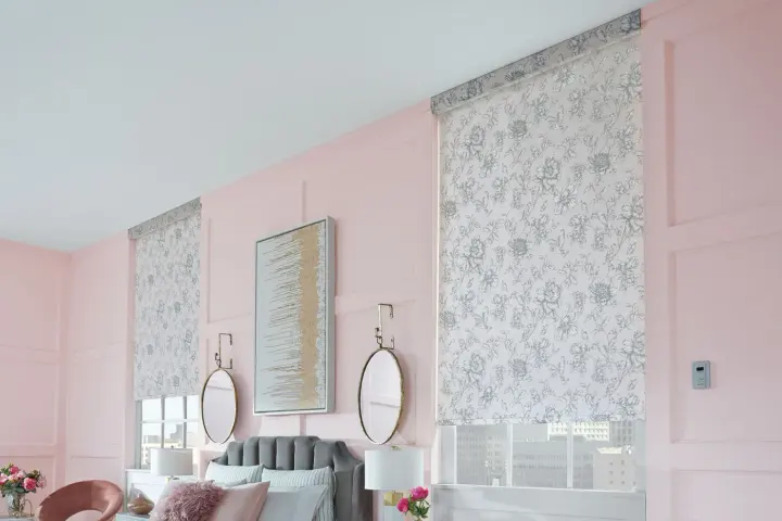 A pink room with designer roller shades.
