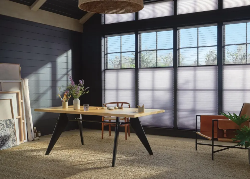 A home office with cellular window shades.