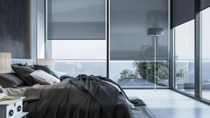 Bedroom with dark motorized shades on large windows