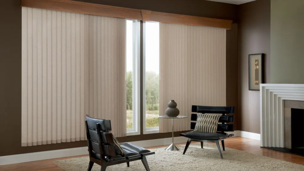 Living room with beige vertical blinds, two black chairs, side table, area rug, and modern fireplace against dark brown walls.