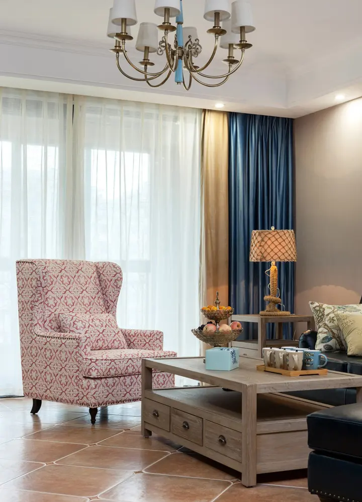 Stylish sitting room with decorative furniture with blue, gold, and white drapery.