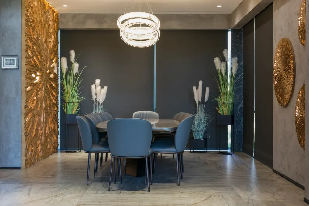 A dining nook with floor-to-ceiling motorized blackout shades.