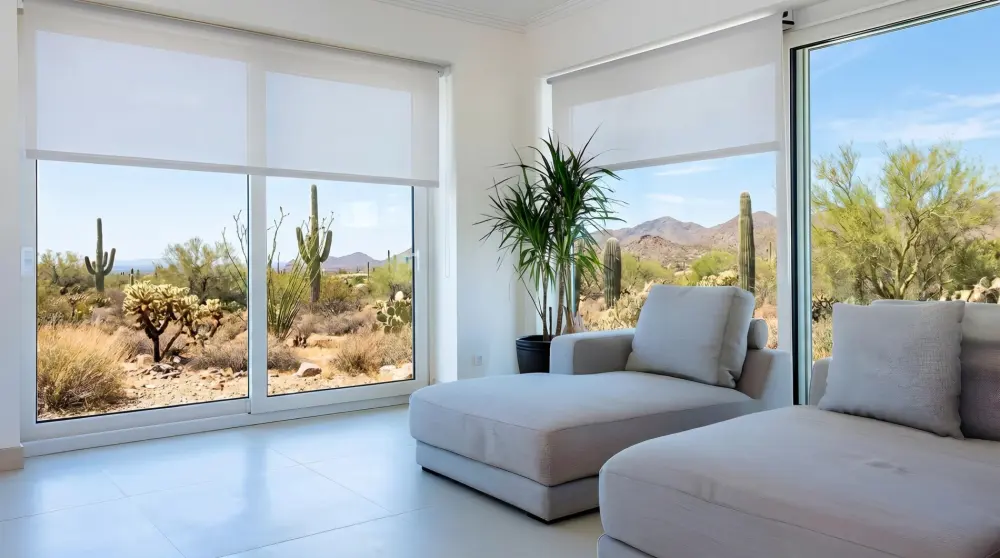 Modern desert home interior with motorized roller shades on large windows.