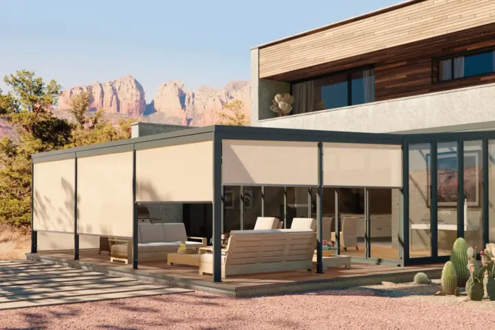 A patio shade outside glassed in sunroom on building, lowered to block the sun in Gilbert, AZ | Southwest Blinds
