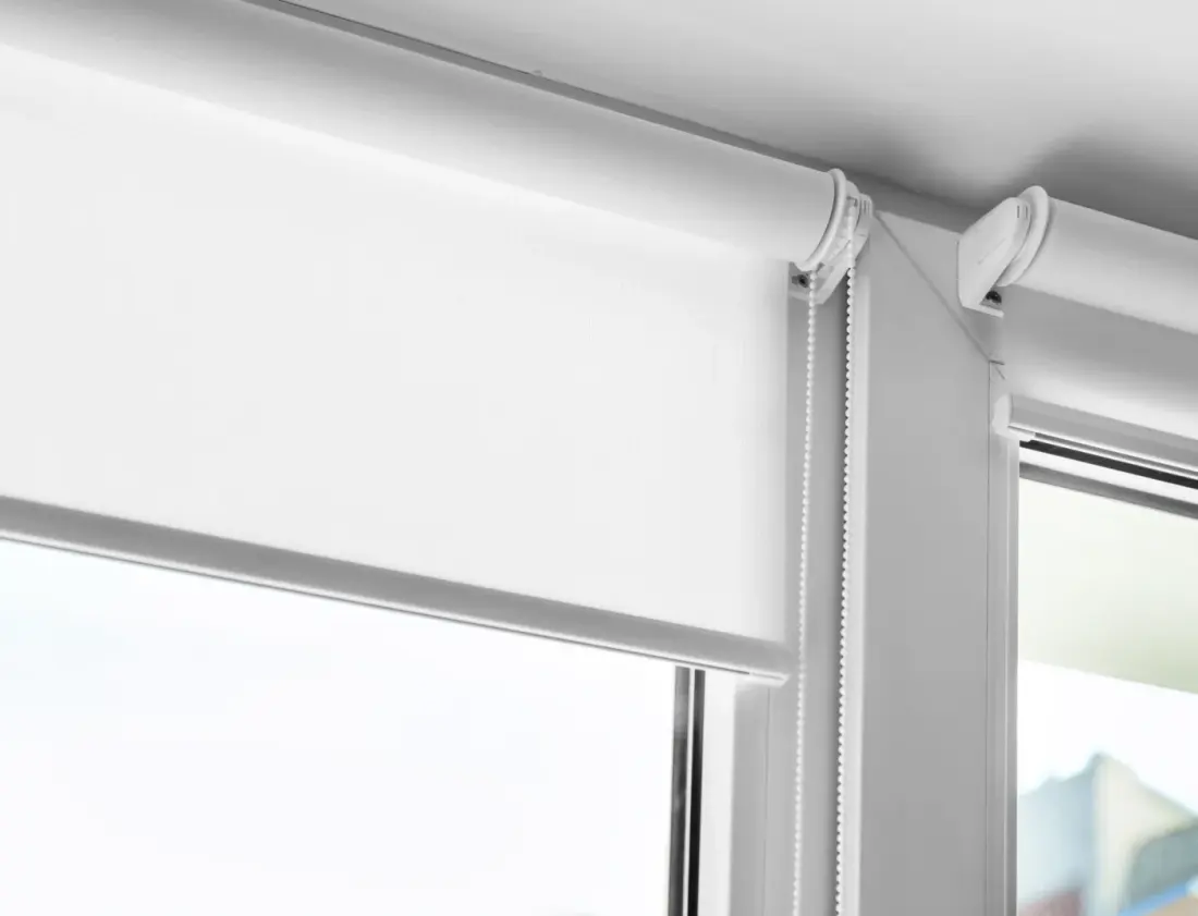 White Roller Blind On A Metal Plastic Window