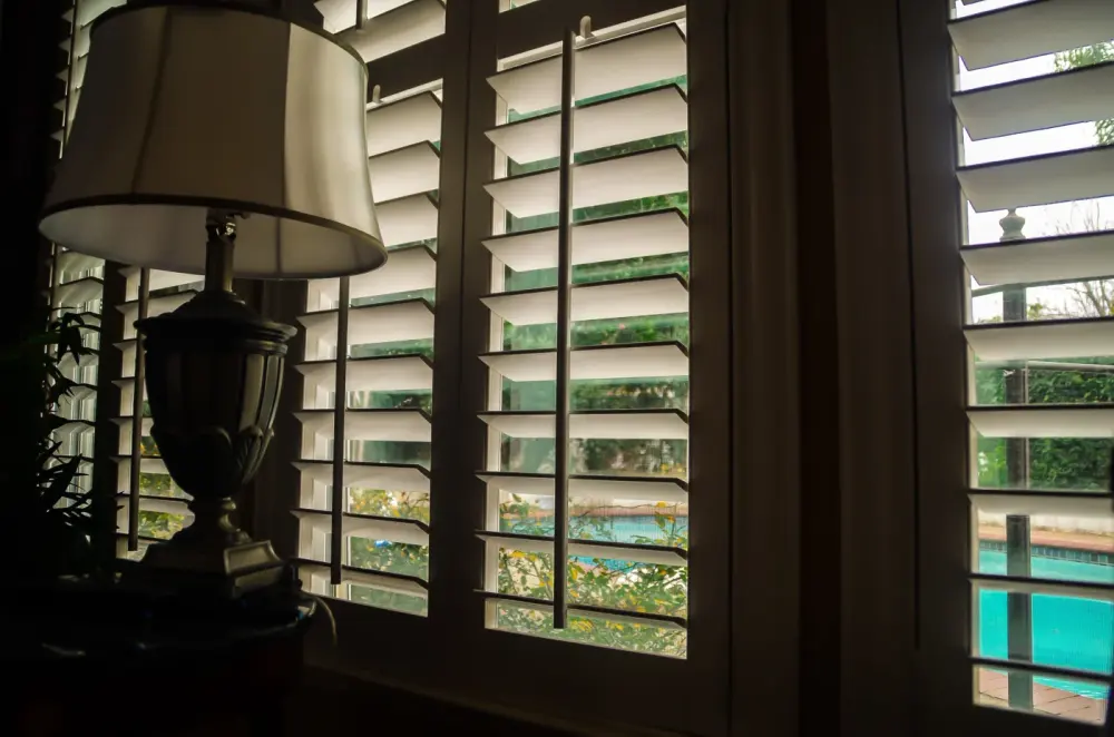 Plantation shutters over a sunny window in a Peoria, AZ home.