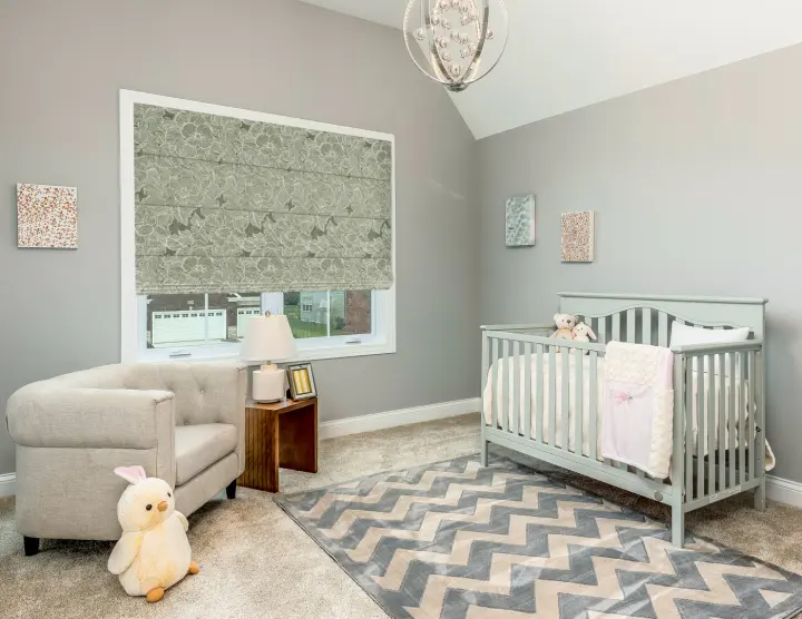 A nursery in a Peoria, AZ home with green patterned window shades.