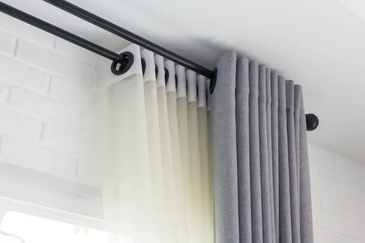 Close-up of drapery hardware with gray drapery supplied by Southwest Blinds & Shutters