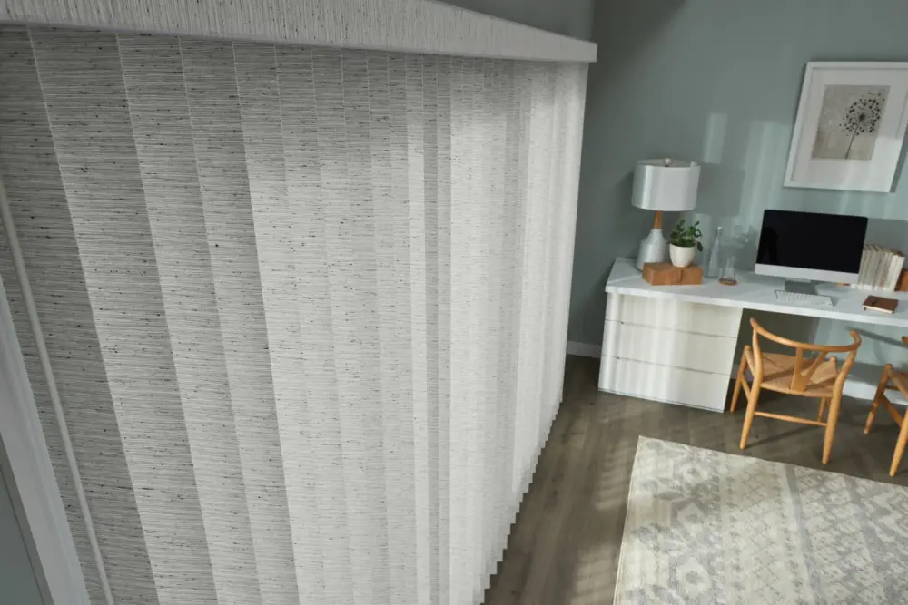 A sliding patio door covered with vertical gray cloth blinds.