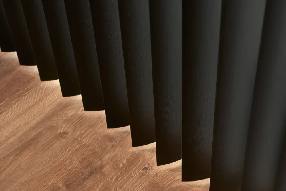Close-up detail of black vertical blinds.
