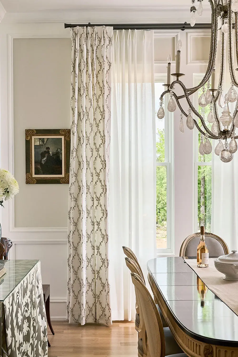 Sheer white drapery are installed in a well-lit room.