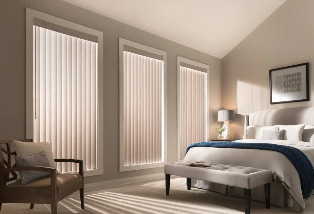 An image of a bedroom with custom vertical blinds covering tall windows 