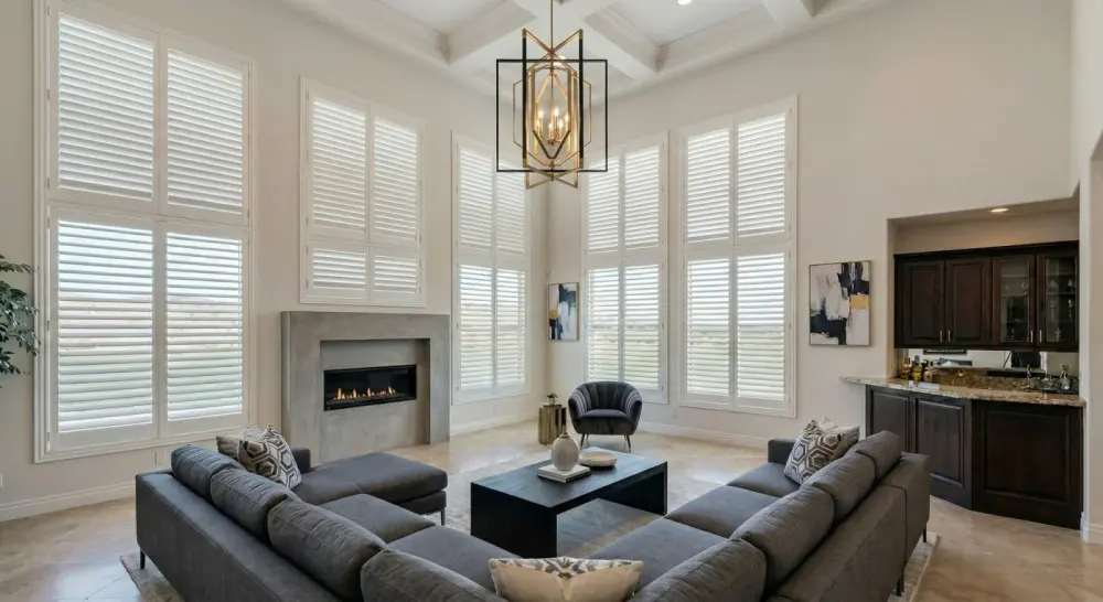 A sitting room with floor-to-ceiling windows covered with indoor shutters.