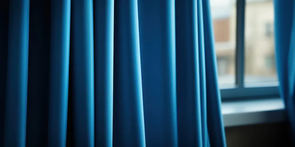 A close-up of thick blue drapery covering the windows in a Glendale, AZ home.