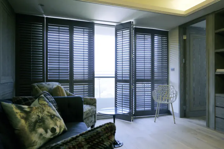 Image of open dark-colored poly shutters on a balcony