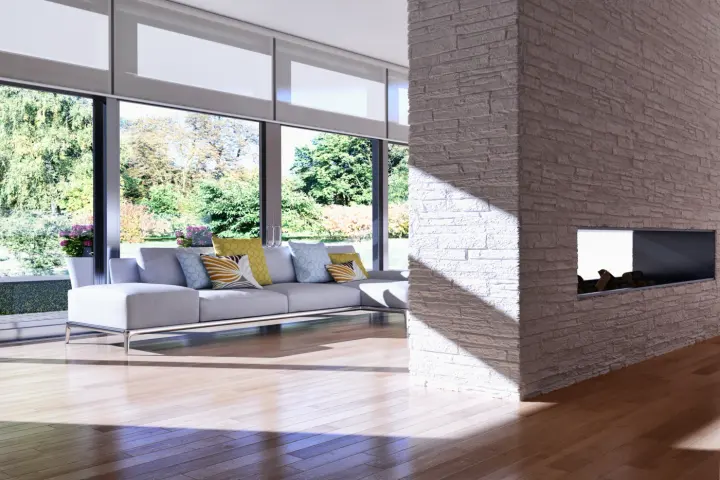 Bright room with motorized shades, a couch, and a fireplace