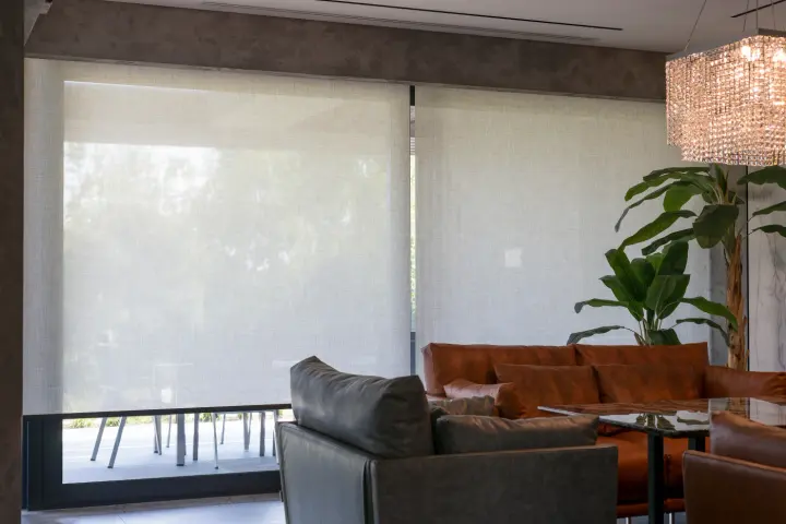 A cozy sitting area with automatic roller shades over the windows.