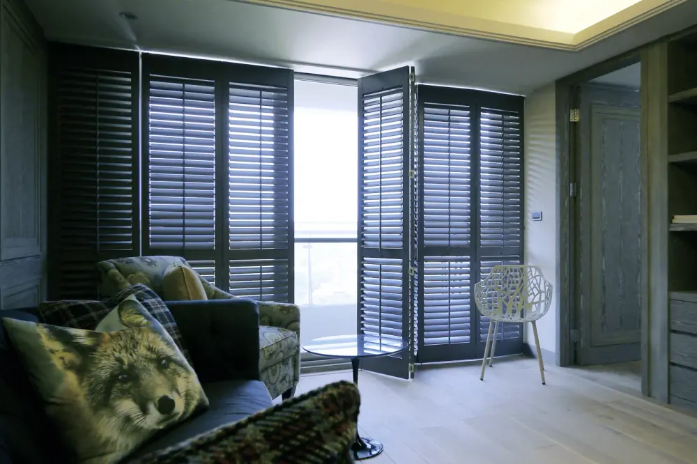 A laundry room with a uniquely shaped ceiling and blinds on the window.
