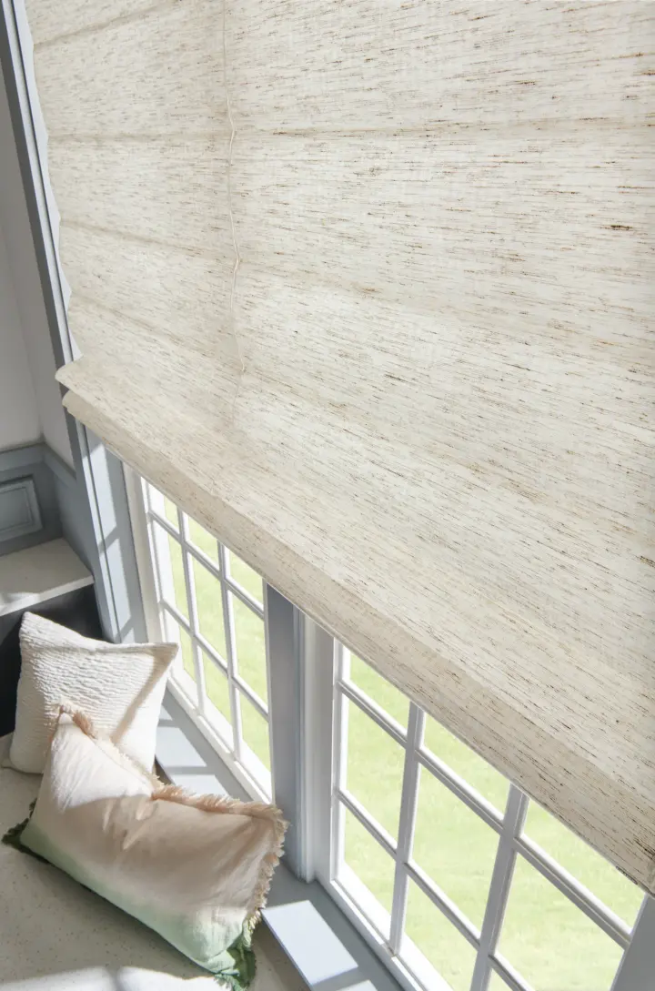 Close-up of the detail on beige motorized shades.