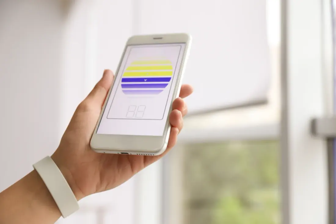 Woman Using Smart Home Application On Phone To Control Window Blinds Indoors, Closeup. Space For Text
