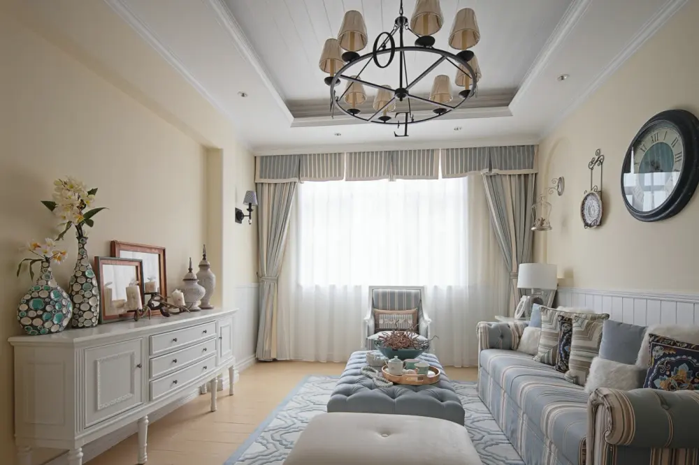 Living room with light yellow walls and elegant furniture, a large window, and striped blue and white drapery.