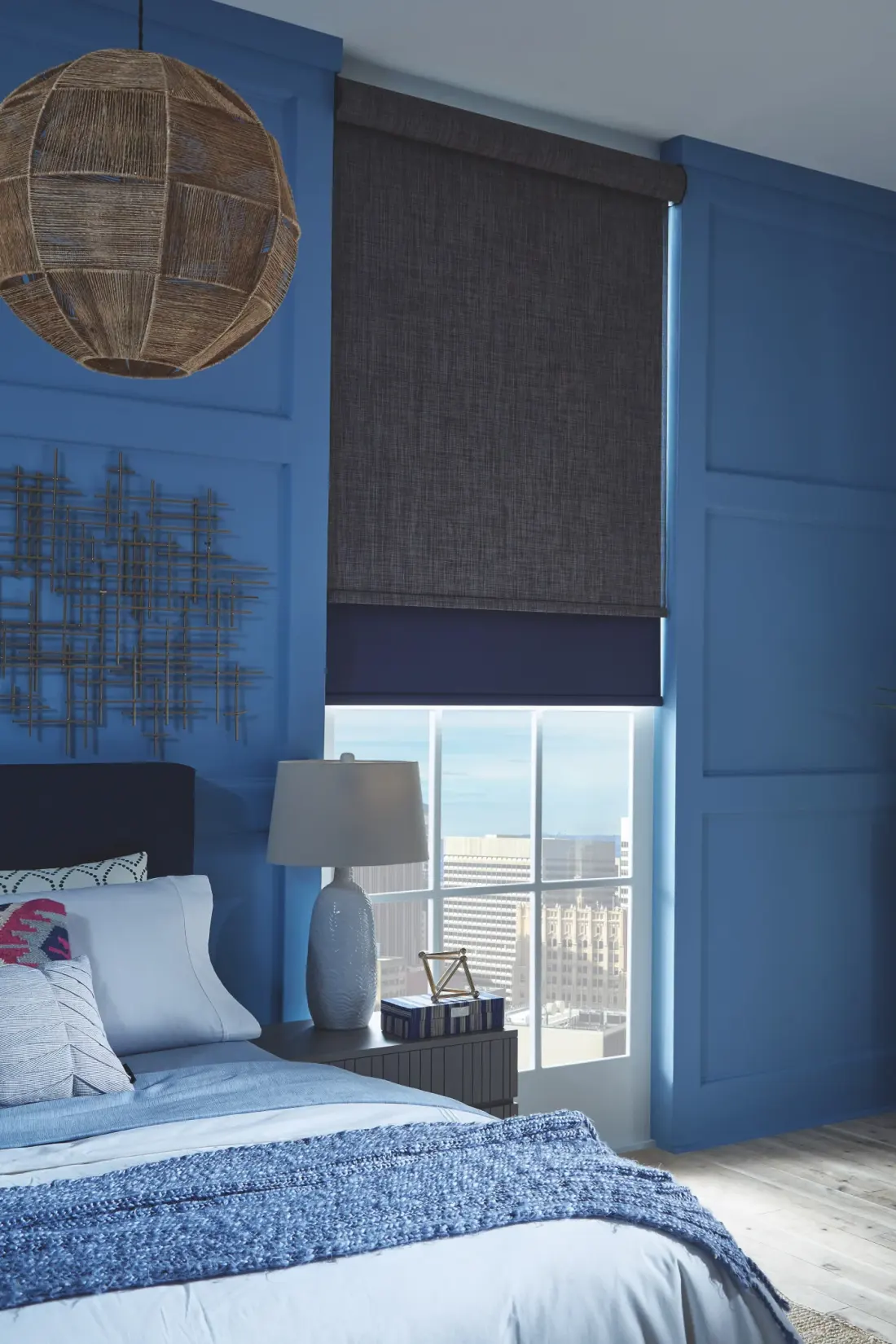 A bedroom with an automatic dual roller shade.