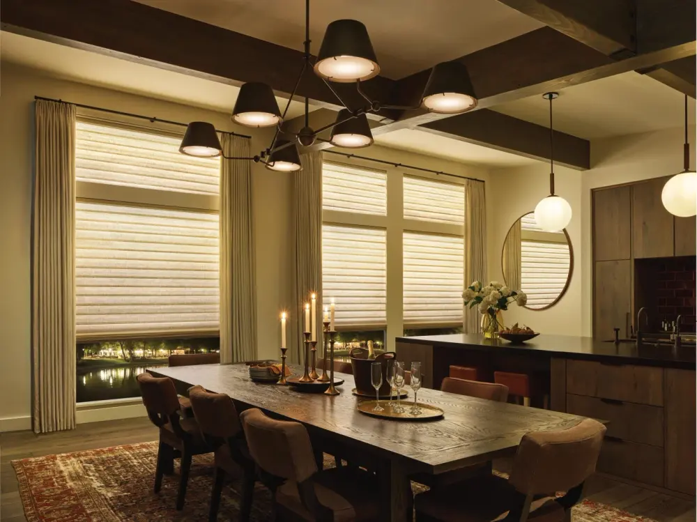 A kitchen lit by candlelight with shades over the windows.
