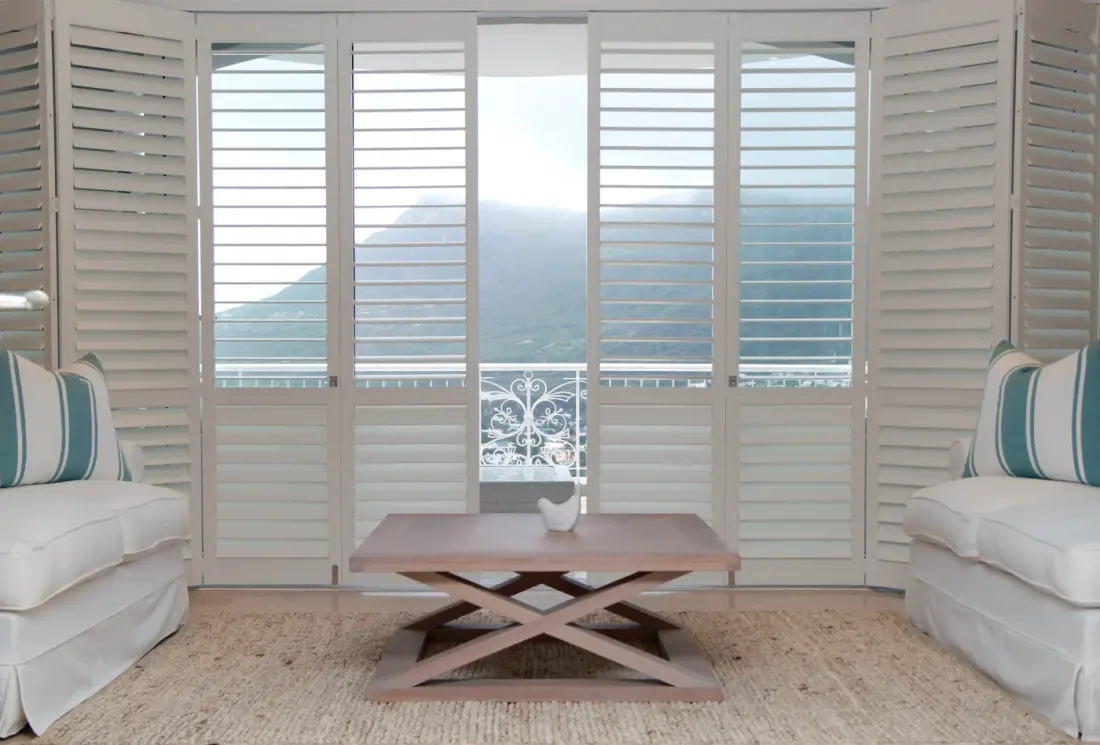 Indoor shutters over a balcony door.
