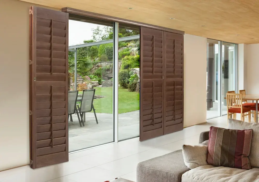 Image of cherry sliding shutters on glass patio doors