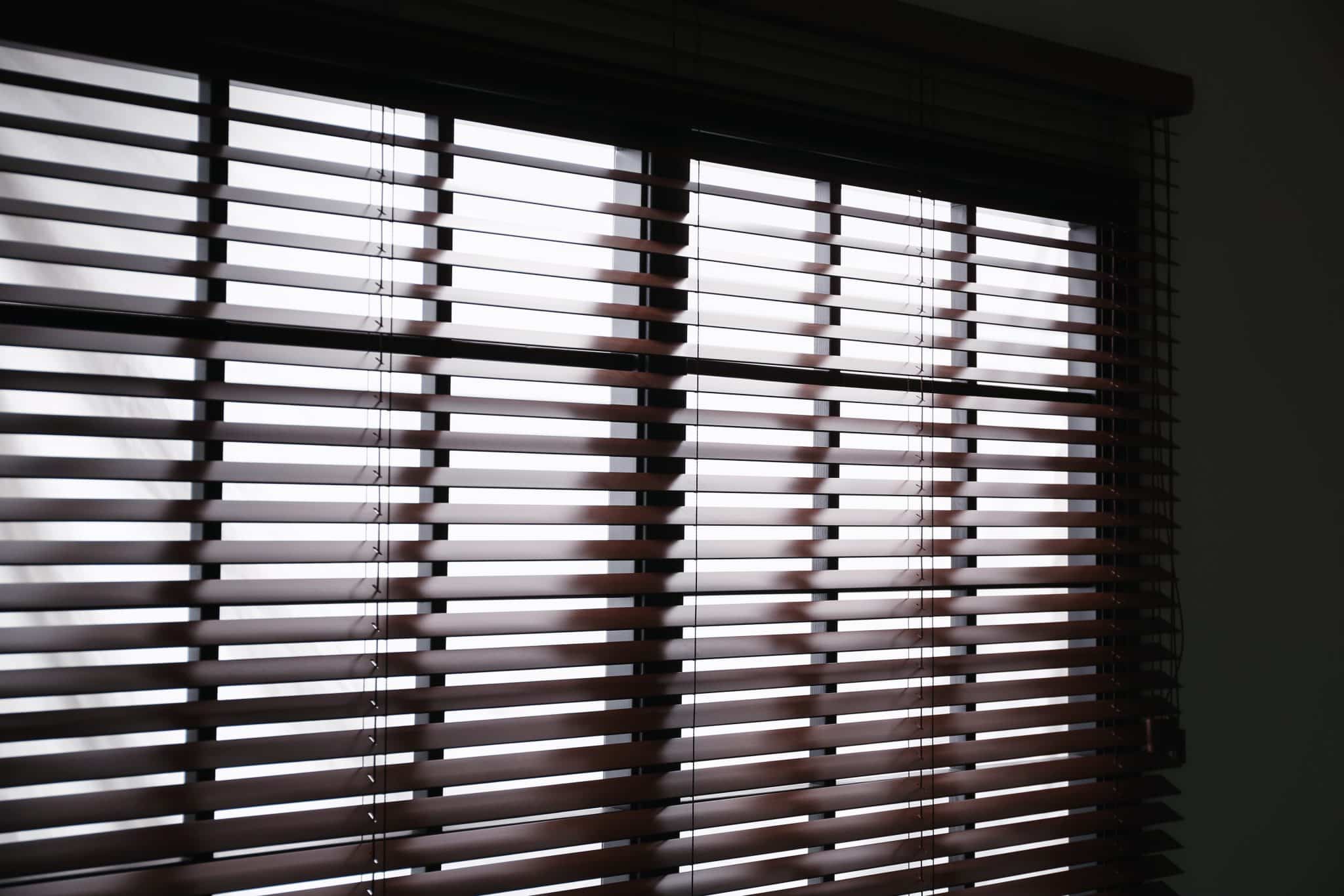 Shutters Installed On Large Window In Front Of Tub In Bathroom